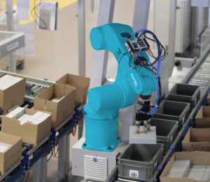 Robot industriel bleu effectuant une opération de picking automatisé sur une ligne de production avec des cartons.